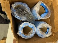 Four blue rolled repair sleeves inside box