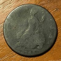 Reverse side showing seated Britannia design, dark patina