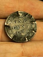 Reverse showing ONE CENT 1887 and three visible rim clips