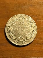 Reverse of 1911 Canadian 25-cent coin showing date, denomination and wreath