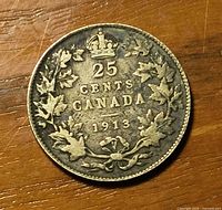 Reverse of 1913 Canada 25 cent coin showing denomination, date and wreath design