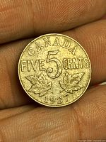Reverse side showing CANADA FIVE CENTS, numeral 5, maple leaves, date 1927