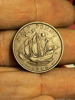 Reverse side of 1948 UK half penny with Golden Hind ship and date