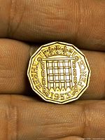 Reverse showing crowned portcullis, date 1953, legend THREE PENCE