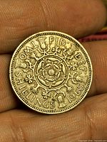 Reverse side of 1965 UK Florin coin showing national floral emblem design and denomination