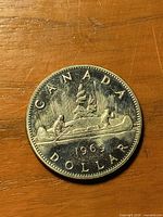 Reverse side showing CANADA 1969 DOLLAR with canoe design