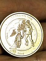 Obverse showing 2010 date, parent and child with sled scene