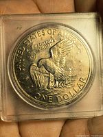 Reverse of 1972 Eisenhower dollar in plastic holder