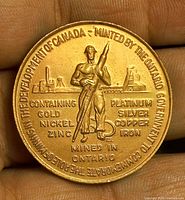 Obverse showing miner, inscriptions of metals, and minting text