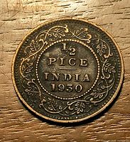 Reverse of 1930 1/2 Pice coin showing denomination and date