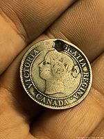 Obverse of coin showing Queen Victoria portrait and holed rim