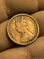 Obverse of 1896 copper coin held in fingers