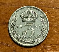 Reverse of 1900 British threepence coin showing crowned 3 and laurel wreath