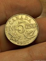 Reverse side showing CANADA FIVE 5 CENTS, maple leaves, 1927 date