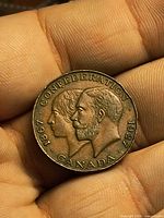 Obverse of bronze medallion with dual portraits and legend