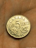 Reverse side showing CANADA FIVE CENTS 5 with maple leaves and 1931 date