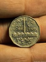 Reverse of 1951 Canadian 5 cent coin showing refinery design and inscriptions