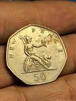 Reverse showing seated Britannia, denomination 50, NEW PENCE legend