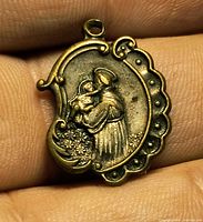 obverse showing relief of St. Anthony holding child with scalloped border