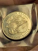 Obverse of 1971 Hamilton anniversary dollar showing worker, ship, crane and expiry date