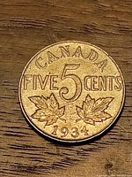 Reverse showing CANADA, FIVE 5 CENTS, maple leaves, 1934 date