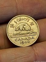 Reverse of 1940 Canadian 5¢ coin showing beaver on log, 5 CENTS and CANADA legend