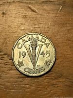 Reverse side showing torch and V, CANADA 1945 5 CENTS
