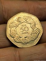 Reverse view showing nine clasped hands and 1973 date