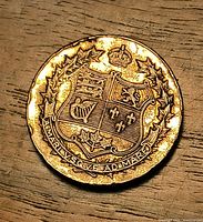 Reverse with Canadian coat of arms, crown, maple wreath, motto