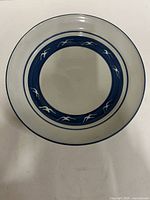 Top view of round stoneware serving bowl showing blue band with white seagull motif