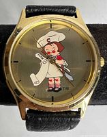 Front view of watch showing Campbell Kids dial and gold-tone case