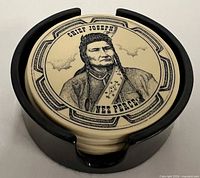 Stacked view of coasters inside holder showing Chief Joseph design