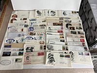 Group view of entire assortment of first day covers spread on table