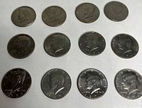 All 12 Kennedy half dollars laid out obverse side