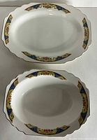 Both oval platters top view showing pattern and size difference