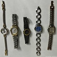Group shot of five women's watches laid out side by side