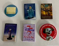 All six Walt Disney pins laid out for identification