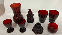 Group shot of all eight cranberry glass pieces