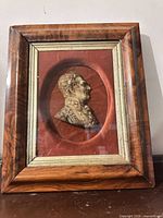 Front view of framed plaster bas-relief portrait