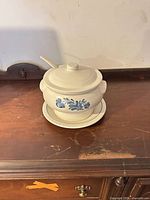 Tureen assembled with lid and ladle on underplate