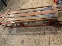 Side view showing wooden slats and red metal runners