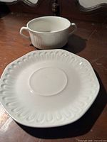 Bowl and saucer close-up showing ribbed bowl and scalloped saucer rim