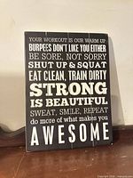 front view of wooden plank wall sign showing full motivational text