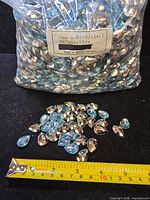 Full bag of light sapphire pear rhinestones with label