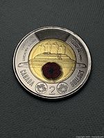 Reverse side showing Tomb of the Unknown Soldier design with red poppy