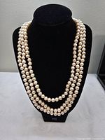 Full view of pearl strand doubled on display bust