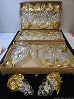 Boxes containing multiple individually wrapped acrylic grape ornaments