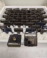 Overview of 49 quartz clock movements in foam tray