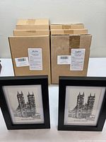 Six sealed boxes and two sample frames front view