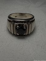 Front view showing black stone and fluted shoulders